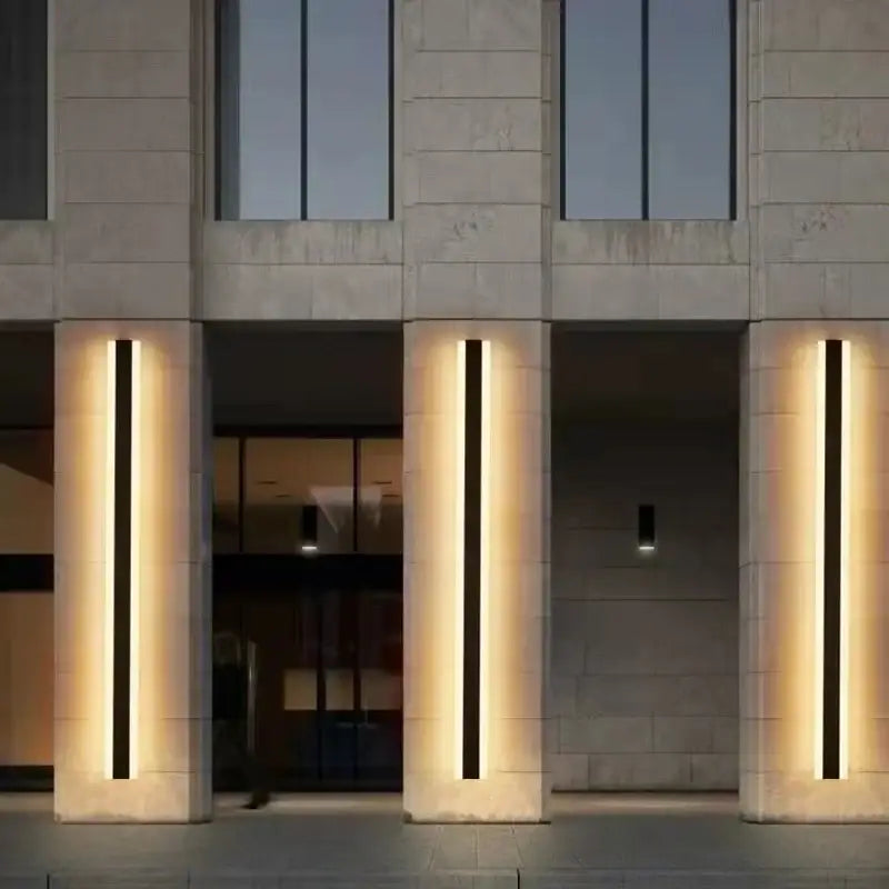 Modern minimalist decorbites™ led outdoor wall lamp with black and amber vertical strips mounted on stone pillars