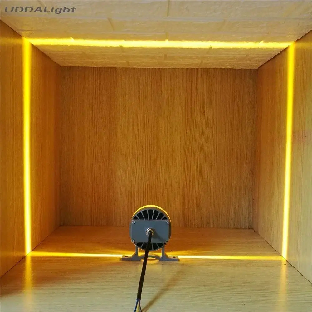 Yellow led strip light with circular gray driver unit mounted on floor for decorbites™ outdoor wall lamp illumination