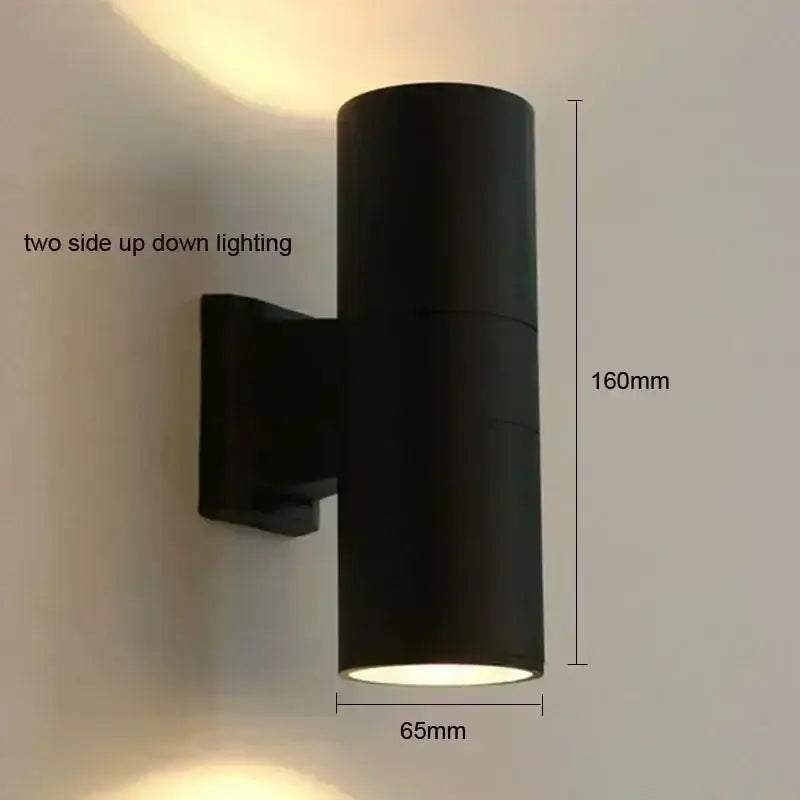 Black cylindrical DecorBites™ outdoor wall lamp with dual up-down LED lighting for porch waterproof use