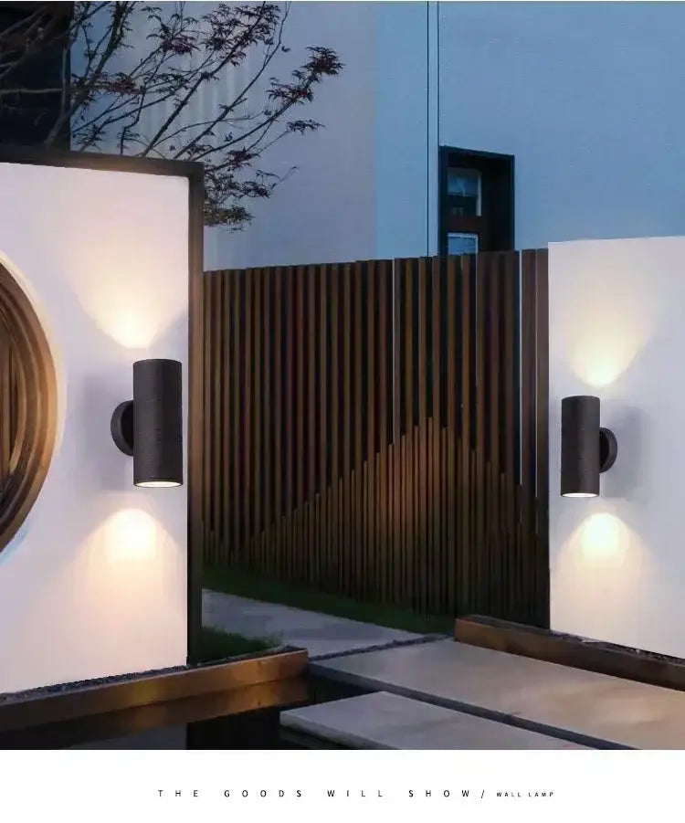 Black cylindrical DecorBites™ LED outdoor wall lamp with sleek modern design and waterproof feature for porch lighting