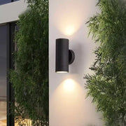 Black cylindrical decorbites™ led outdoor wall lamp with dual downward-facing lights for porch lighting