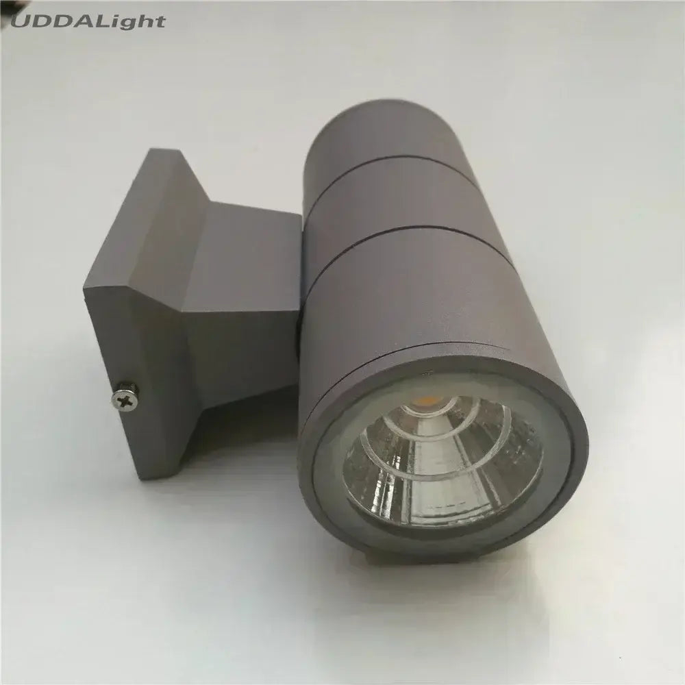 Gray aluminum decorbites™ led outdoor wall lamp with cylindrical head and rectangular bracket for outdoor wall mounting
