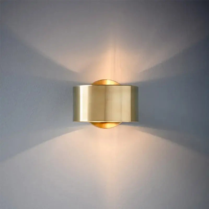 Brass cylindrical wall light with sleek modern design casting warm light for decorbites led outdoor wall use