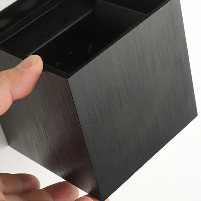 Black brushed metal desk organizer with multiple compartments next to the DecorBites™ outdoor wall light waterproof lamp