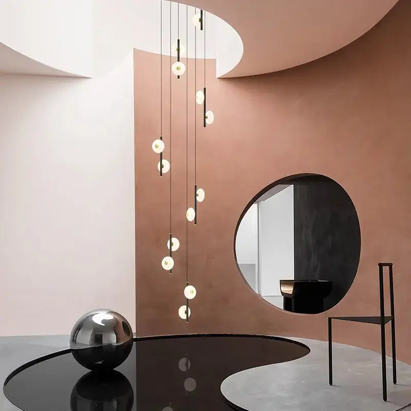 Shiny metallic sphere on reflective black surface complementing decorbites led oval chandelier for modern indoor lighting