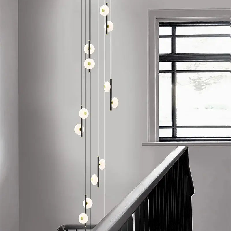 Modern minimalist decorbites led oval chandelier with spherical white glass globes and thin black cords for indoor lighting