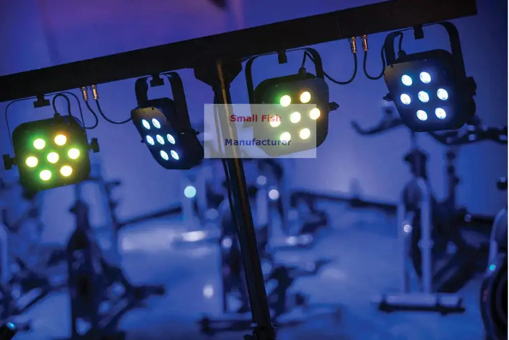 Three black led par stage lights with bright green and blue bulbs suspended from a metal rig in decorbites led par kit