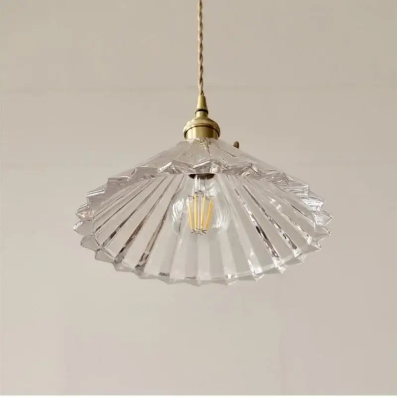 Clear fan-shaped glass pendant lamp with brass fixture and exposed filament bulb by DecorBites LED pendant lamp