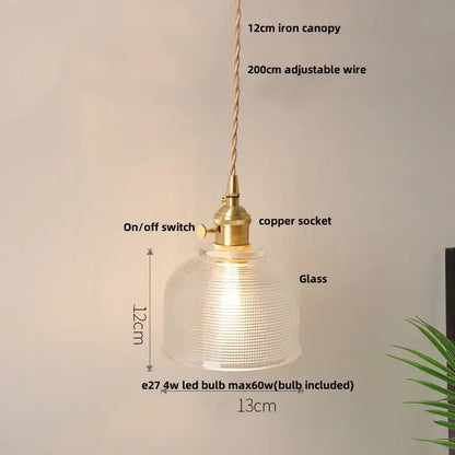 A warm-glowing DecorBites LED pendant lamp with a textured clear glass dome and brass-finished hardware