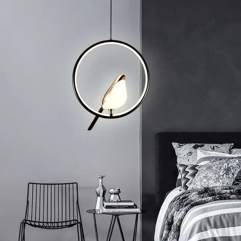 Modern decorbites led pendant lamp with gold bird-shaped lampshade suspended in black circular frame for bedroom interior
