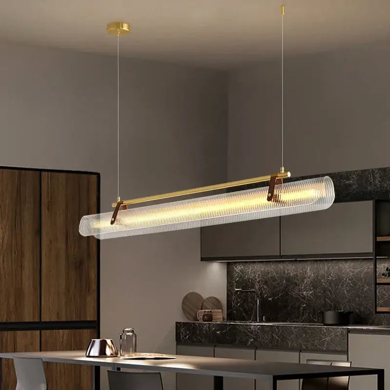 Modern gold-toned decorbites led pendant lamp with textured translucent glass diffuser and sleek metal frame for dining room