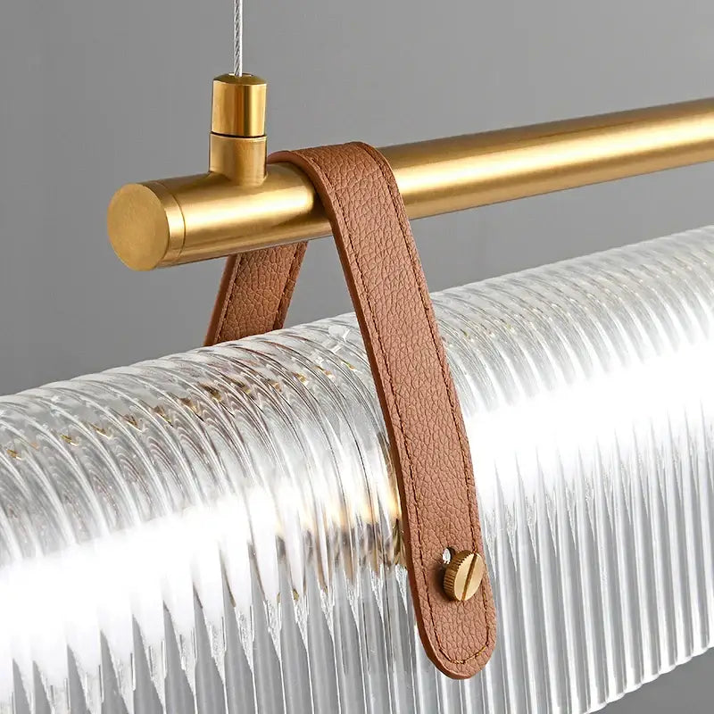 DecorBites led pendant lamp with gold metal rod, clear ribbed glass shade, and tan leather strap for dining or kitchen lighting