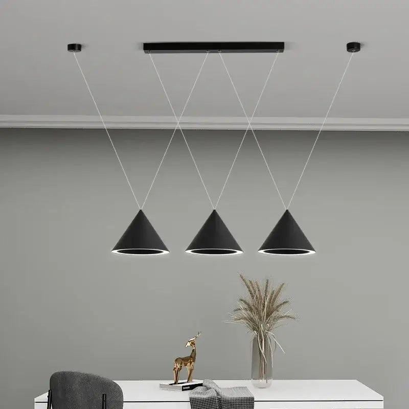 Three sleek black decorbites led pendant lights with matte finish and white trim for kitchen island and dining table lighting
