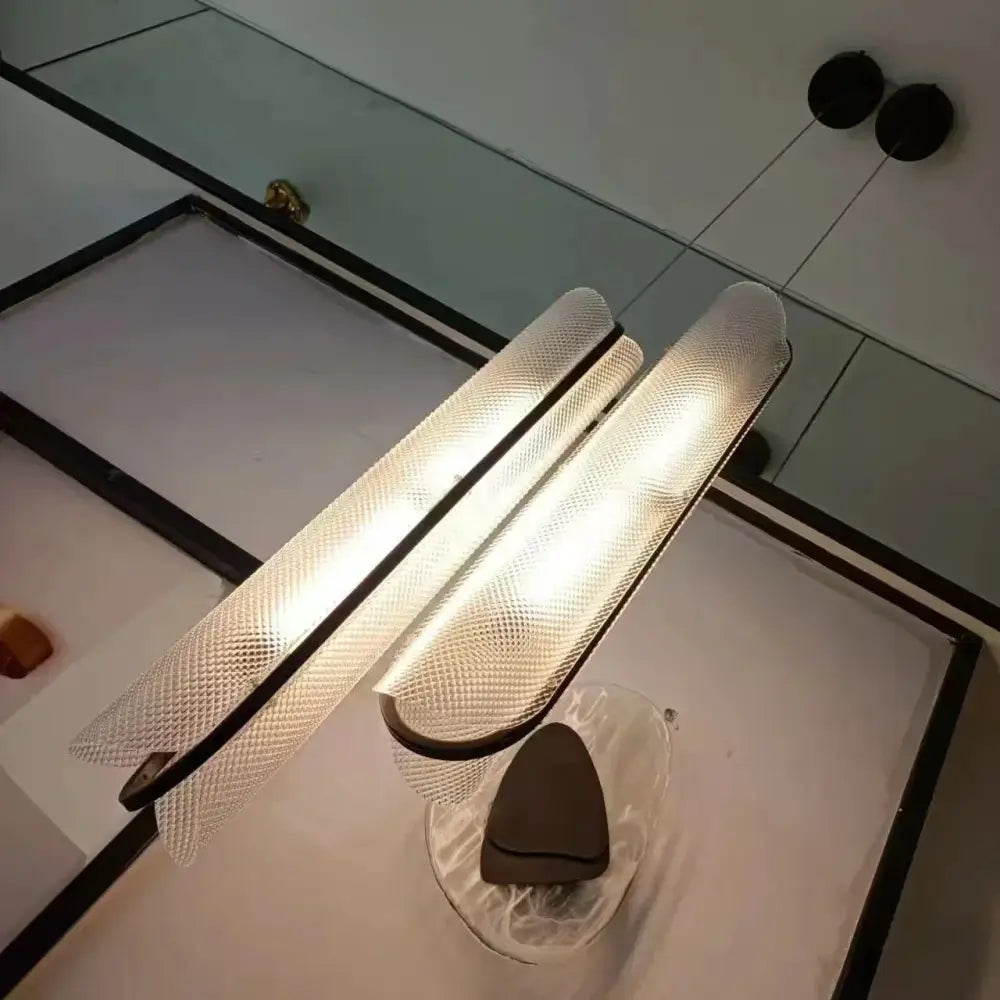 Two illuminated decorbites led pendant glass sconces with textured diamond pattern and dark metal frames for modern lighting