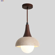 Decorbites led pendant lamp with matte brown metal stem and off-white concrete dome encasing glowing white glass ball bulb