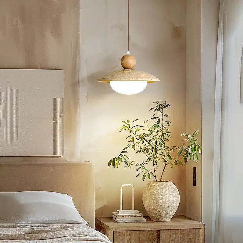A warm-toned decorbites led pendant lamp with a wooden spherical top and beige travertine disc shade