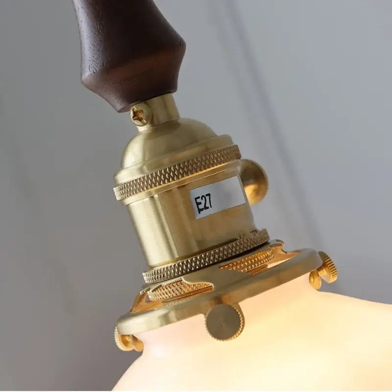 Decorbites led pendant lamp with brass socket, dark wood handle, and textured metallic accents for elegant lighting