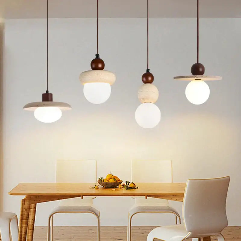 Four matte white concrete shade pendant lamps with dark brown accents hang above wood table decorbites led pendant