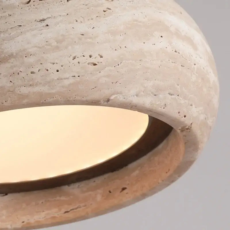Beige stone decorbites led pendant lamp with warm glowing circular glass diffuser for ambient lighting