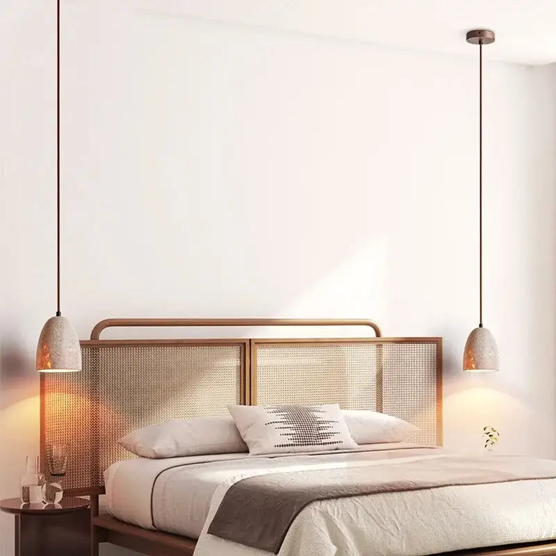 Two decorbites led pendant lamps with textured off-white ceramic shades and dark metal cords in japanese style