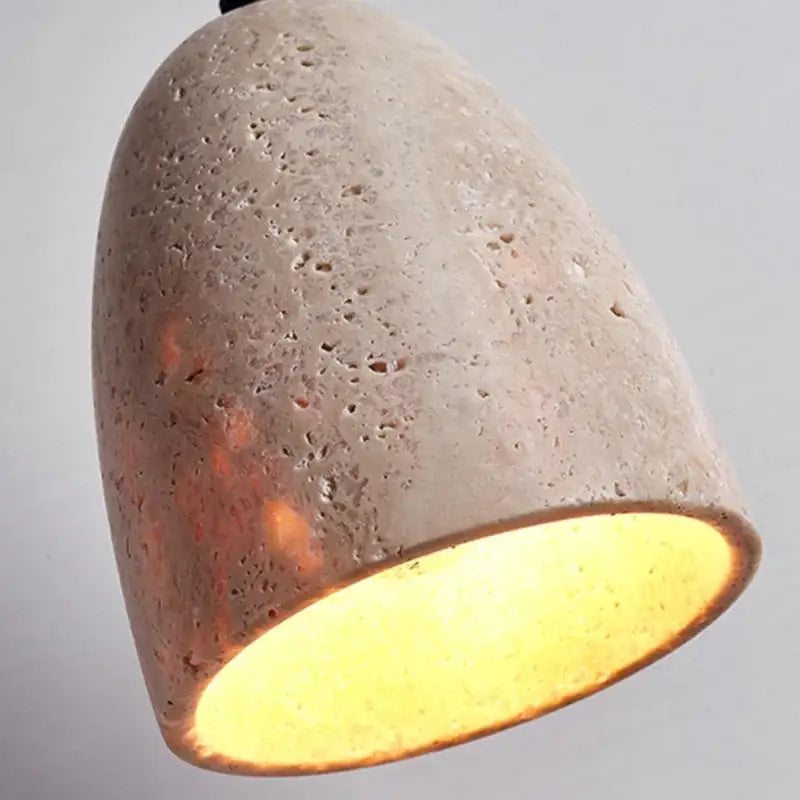 Decorbites led pendant lamp in yellow travertine features a textured light gray concrete pendant lamp with warm interior glow