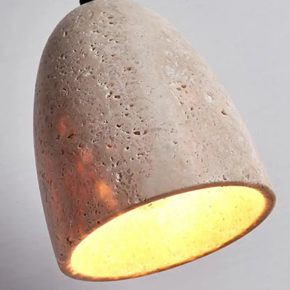 DecorBites led pendant lamp featuring a textured light gray concrete shade with warm yellow travertine interior glow