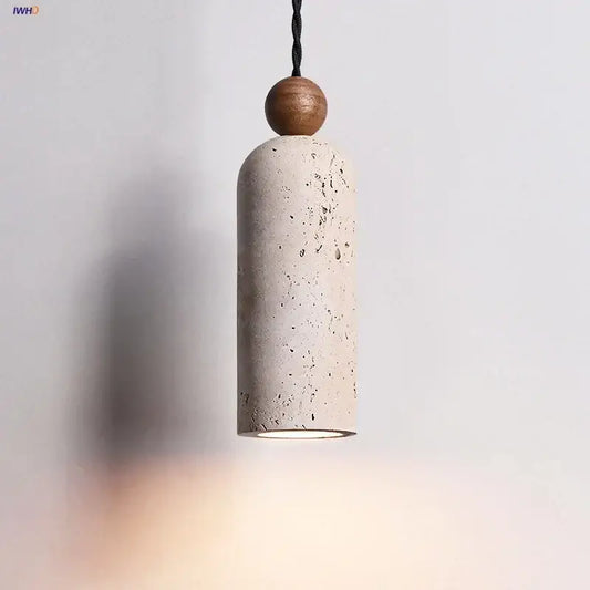 Decorbites led pendant lamp with a textured off-white concrete body, yellow travertine wood sphere, and black braided cord