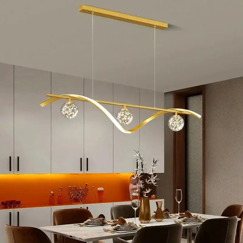 Gold-toned decorbites led pendant lamp with curved metallic frame and crystal globe bulbs for dining room lighting