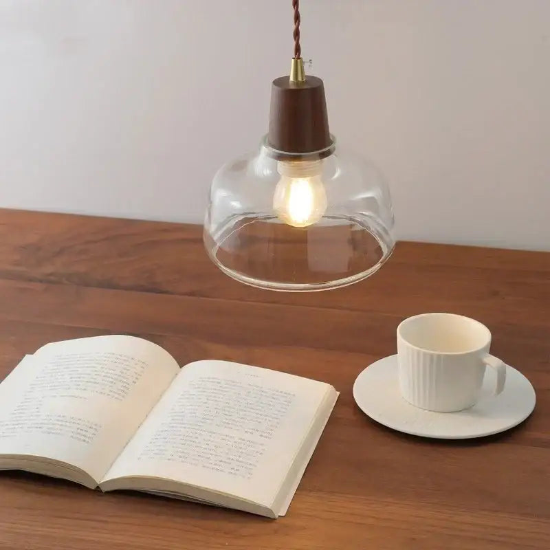 Warm-toned decorbites led pendant lamp with clear glass globe walnut wood top and twisted cord for modern home decor