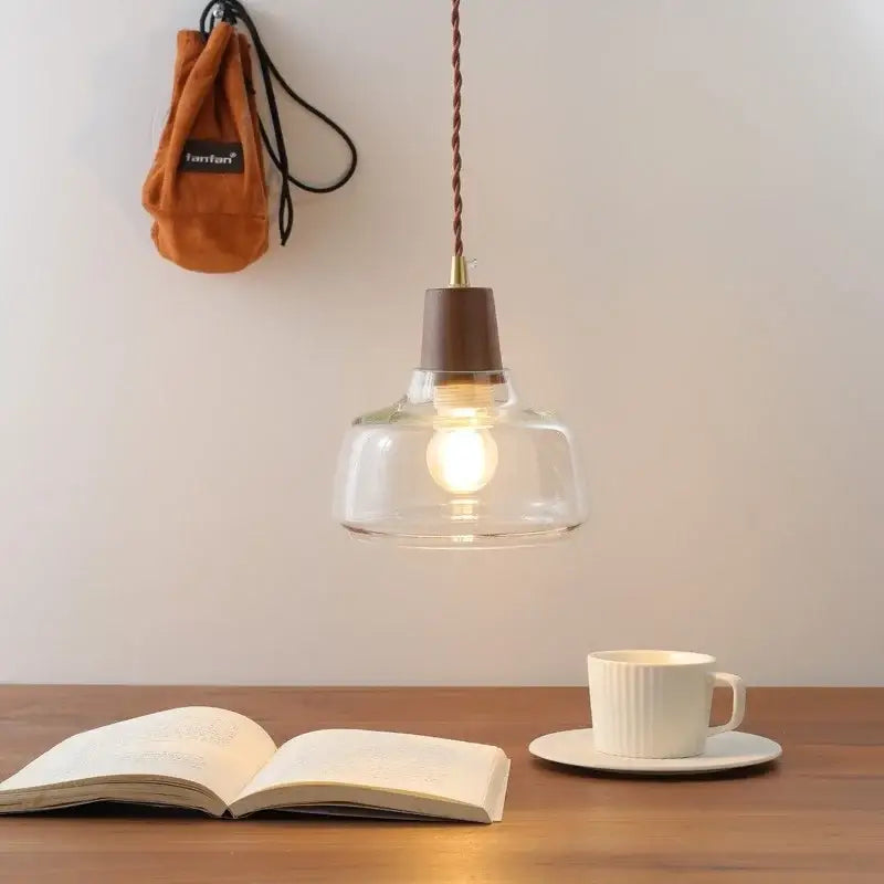 Clear glass pendant lamp with brown wooden top and twisted copper cord from decorbites led pendant collection