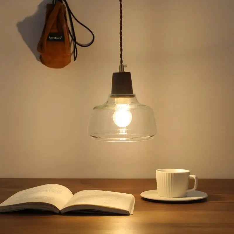 Warm-toned walnut glass pendant lamp with dark metal fixture and twisted cord by DecorBites led pendant for modern decor