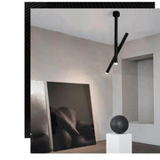 Black minimalist DecorBites LED pendant light with two intersecting aluminum arms for living room and kitchen use