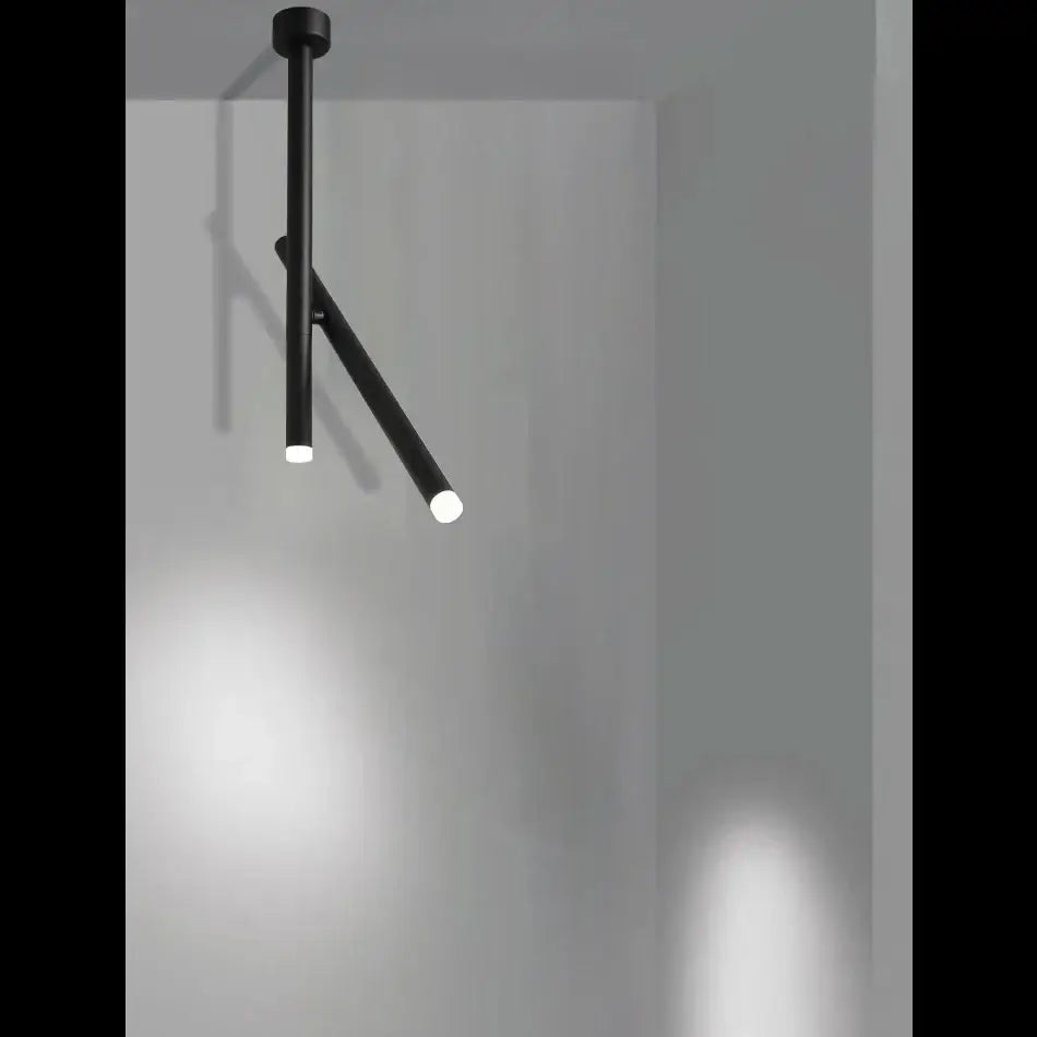 Black minimalist DecorBites LED pendant light with adjustable aluminum rods emitting soft white illumination for living room