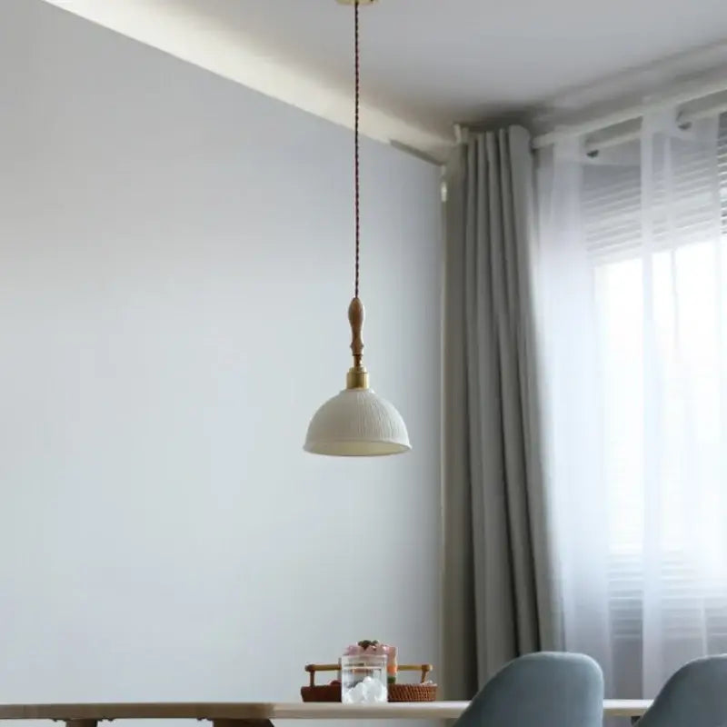 DecorBites led pendant light with white textured ceramic shade, brass fixture, and ash wood accent in Japanese style design