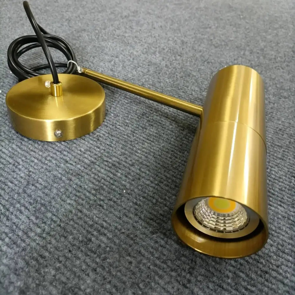 Brass-finished adjustable wall-mounted led spotlight with cylindrical head and circular base from decorbites led pendant light collection