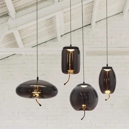 Dark glossy glass decorbites led pendant light with warm bulbs and black cords for modern living and dining rooms