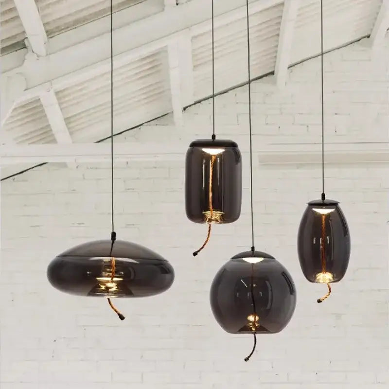 Dark glossy glass decorbites led pendant light with warm bulbs and black cords for modern living and dining rooms