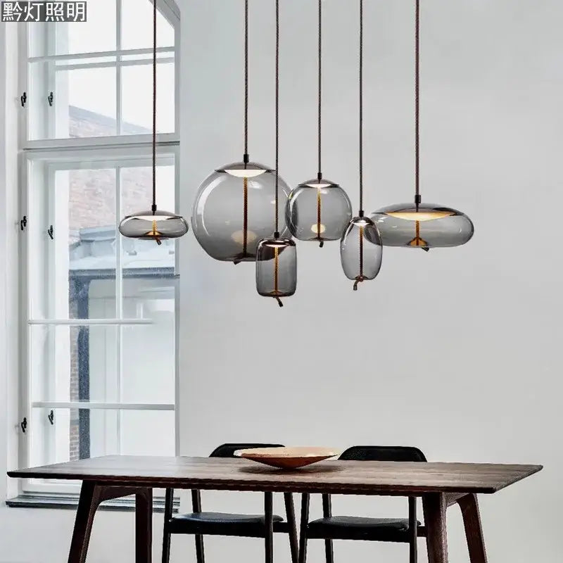 Modern gray glass decorbites led pendant light chandelier with warm interior illumination for living and dining rooms