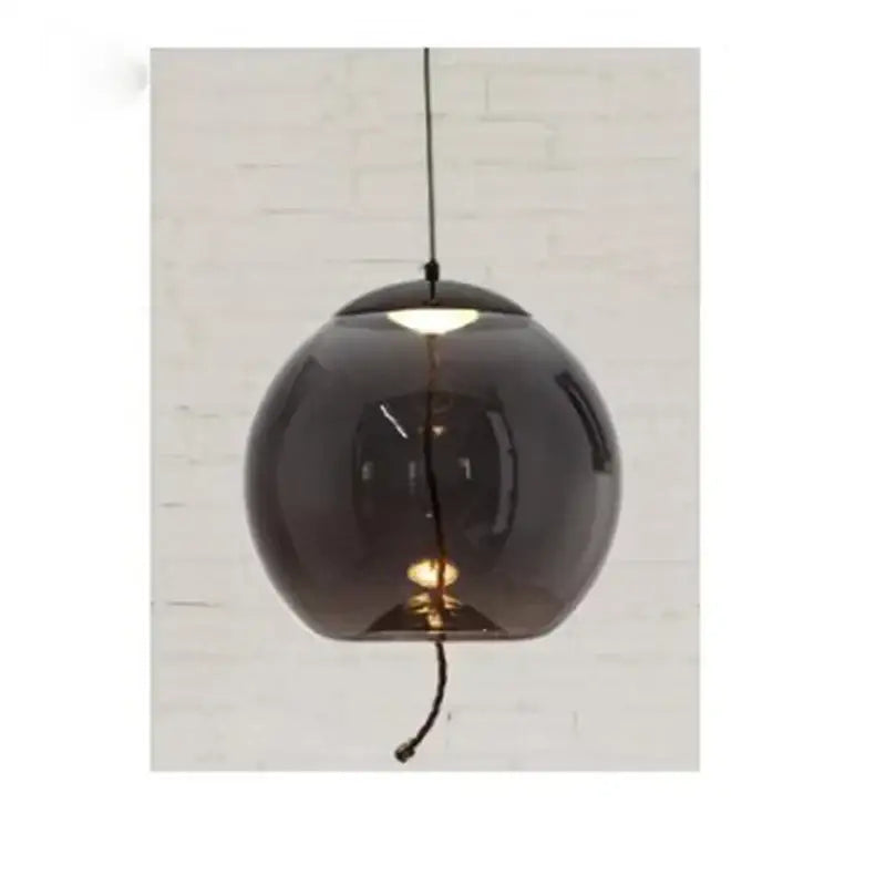 A sleek dark smoked glass spherical pendant light with visible bulb for modern living by DecorBites led pendant