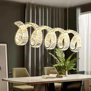 A modern gold-toned DecorBites led pendant light chandelier with five interlocking spiral rings for living room decor