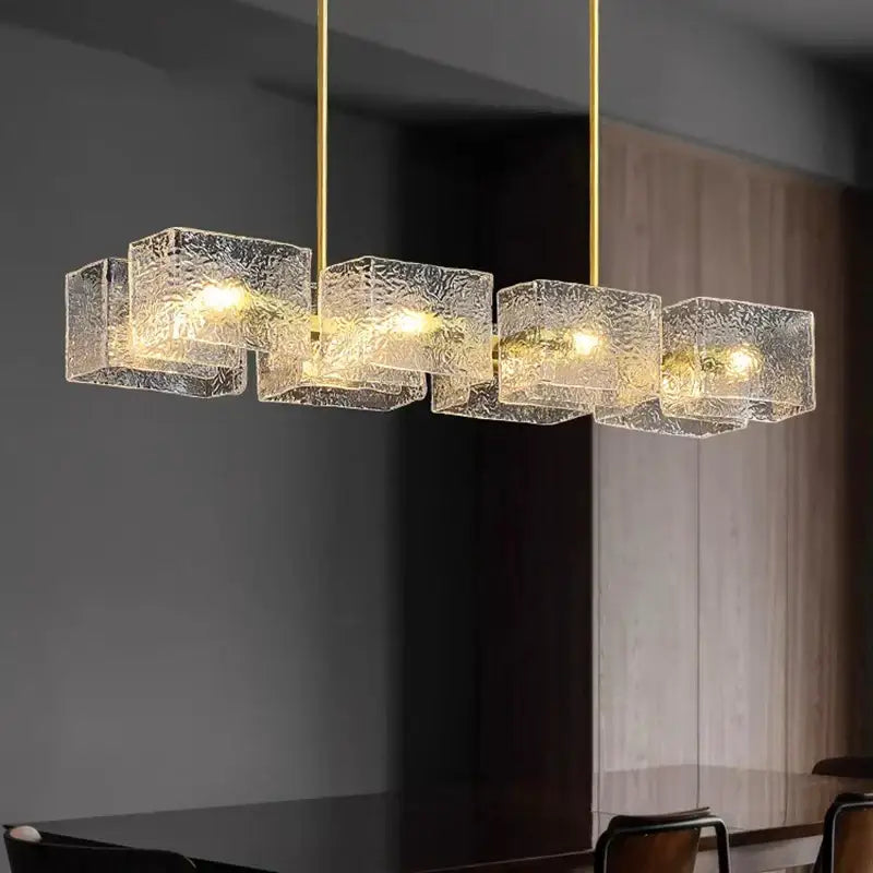 Modern gold-toned decorbites led pendant light with five textured glass cubes in a linear row for indoor use