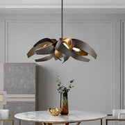 Modern pendant light with sculpted layered metal petals in brushed gold and matte black finish by decorbites led pendant