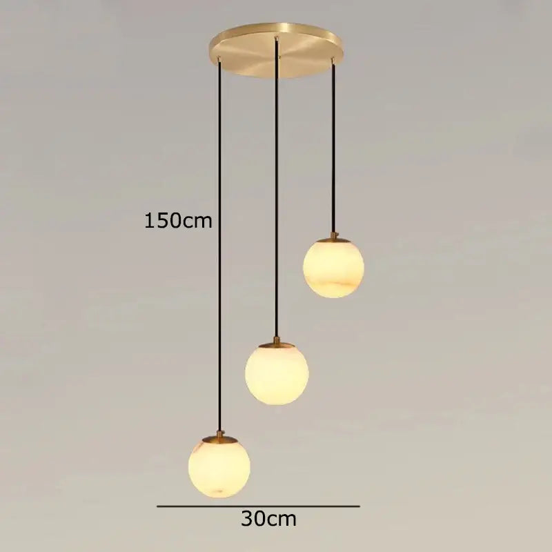 Modern brass-finished decorbites led pendant light with three frosted glass globes for indoor living room lighting