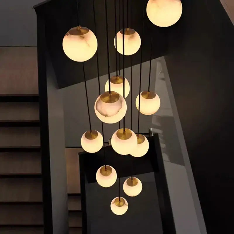 Modern spherical DecorBites led pendant lights with warm opal glass and brass accents for living room indoor lighting