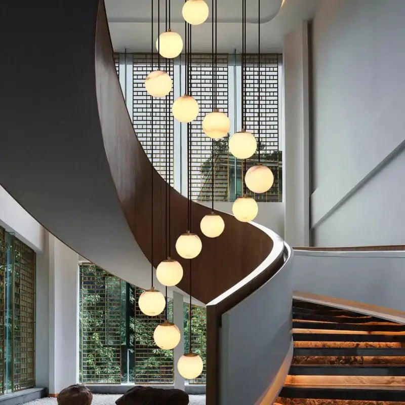 A modern decorbites led pendant light chandelier with warm spherical glass globes and black cords for indoor use