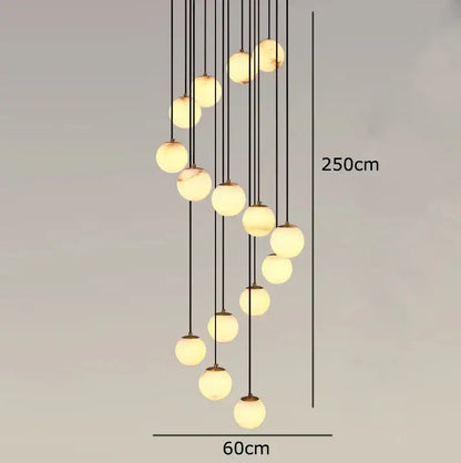 A modern decorbites led pendant chandelier with spherical glass globes and black cords providing warm living room light