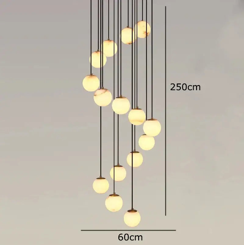 A modern decorbites led pendant chandelier with spherical glass globes and black cords providing warm living room light