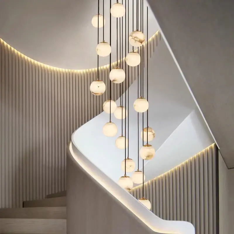 Modern chandelier featuring spherical frosted glass orbs suspended by black cords in decorbites led pendant lights