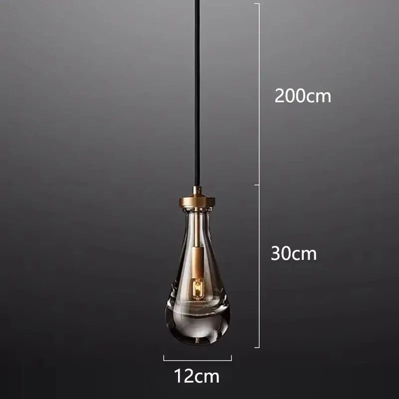 A sleek teardrop-shaped decorbites led pendant light with brass-finished metal top for indoor living room lighting