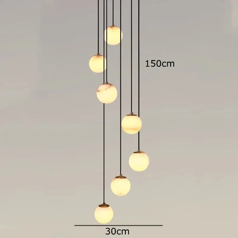 Modern decorbites led pendant light with seven cream marbled glass globes suspended by black cords for indoor use